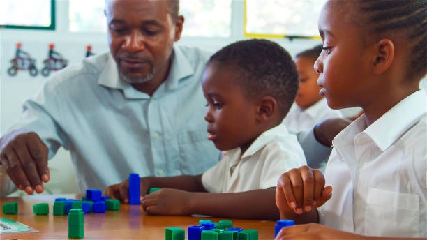 teacher with students playing blocks