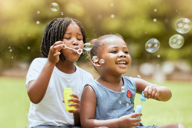 two black girls blowing bubbles