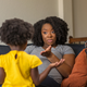Mother giving instructions to young child at home