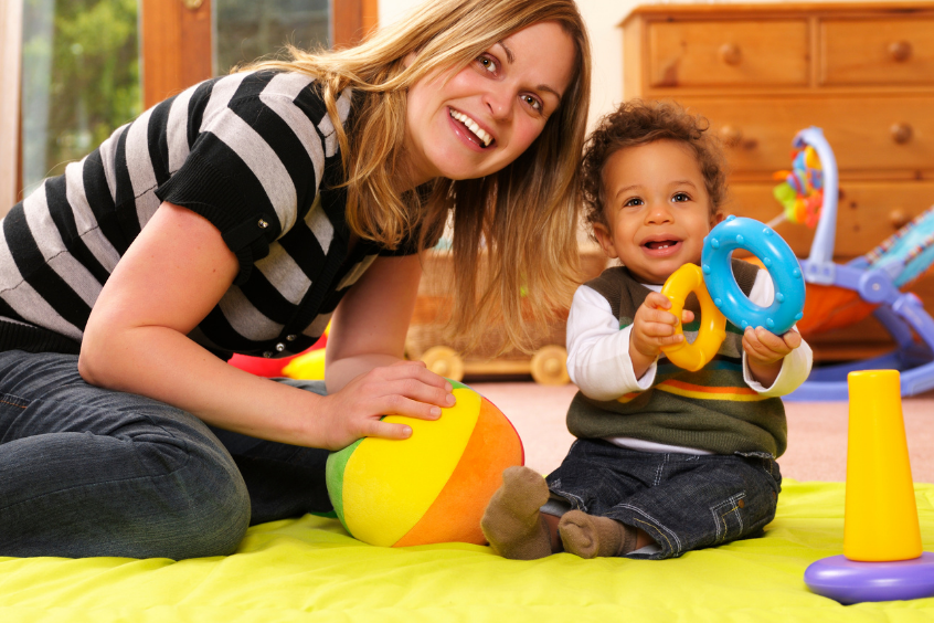 Baby enjoying playtime using a stacker toy
