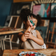 Joyful child showing painted hands in a vibrant art studio setting