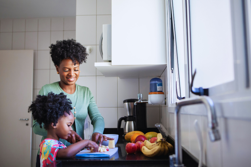 Mother and daughter preparing food together in the kitchen 