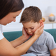 Mother comforting a young boy who appears upset