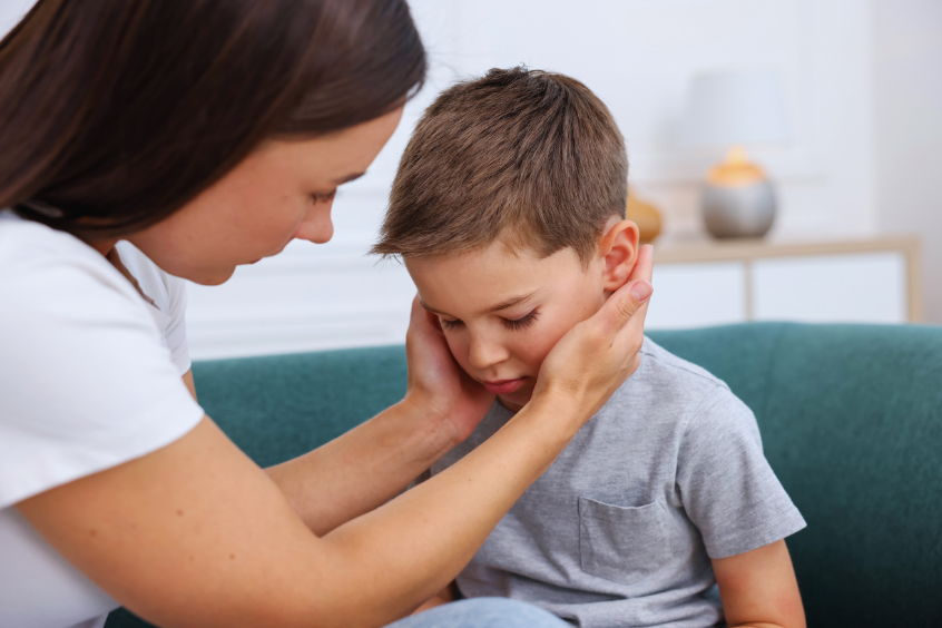 Mother comforting a young boy who appears upset
